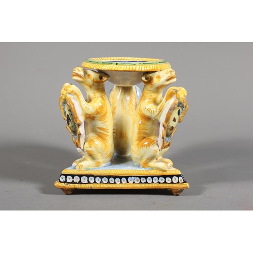 33 - Majolica style centrepiece, central dish painted with portrait, over triple lion stand.