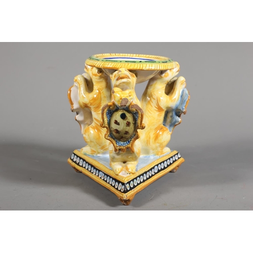 33 - Majolica style centrepiece, central dish painted with portrait, over triple lion stand.