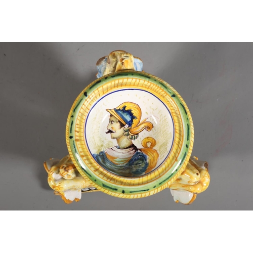 33 - Majolica style centrepiece, central dish painted with portrait, over triple lion stand.