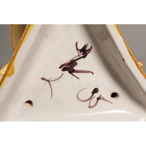 33 - Majolica style centrepiece, central dish painted with portrait, over triple lion stand.