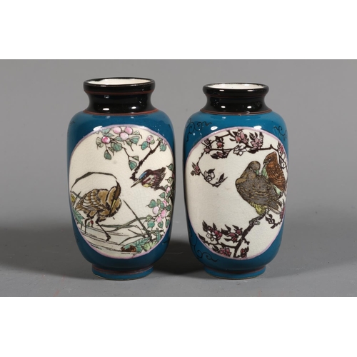 35 - Pair of Japanese style  miniature vases, green ground with lozenge panels depicting birds, 10cm high... 