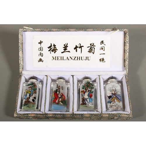 45 - Meilanzhugu set of four perfume bottles decorated with characters.