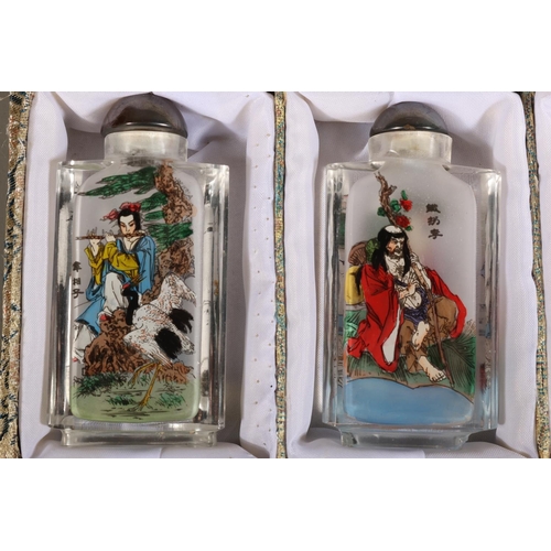 45 - Meilanzhugu set of four perfume bottles decorated with characters.