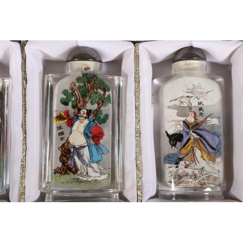 45 - Meilanzhugu set of four perfume bottles decorated with characters.