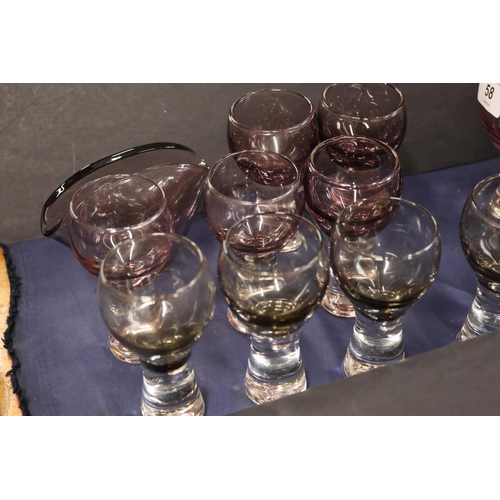 58 - Smoked glass decanters and glasses.