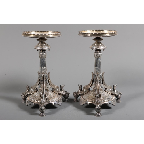 6 - Pair of plated table stands with scalloped circular top on elaborate baluster column, mounted by tri... 