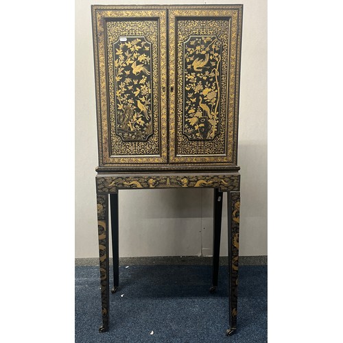 518 - Japanese lacquered cabinet on stand, rectangular top over door enclosing cupboard and drawers, raise... 