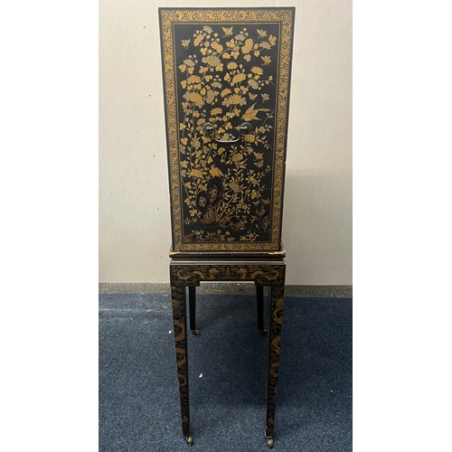 518 - Japanese lacquered cabinet on stand, rectangular top over door enclosing cupboard and drawers, raise... 