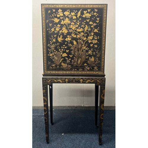 518 - Japanese lacquered cabinet on stand, rectangular top over door enclosing cupboard and drawers, raise... 