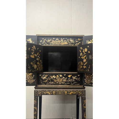 518 - Japanese lacquered cabinet on stand, rectangular top over door enclosing cupboard and drawers, raise... 