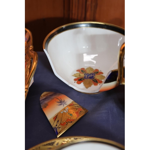 463 - Noritake of Japan, a thirty-eight piece bone china tea set decorated with Indian scenes depicting an... 