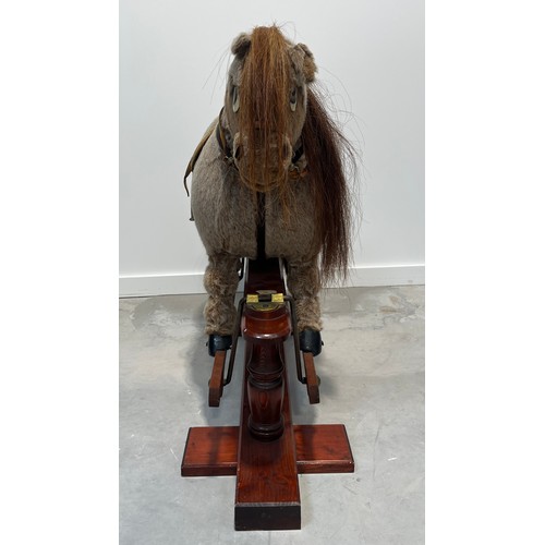 1184 - Norman Thelwell rocking horse on trestle stand, 113cm long.