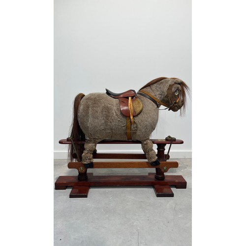 1184 - Norman Thelwell rocking horse on trestle stand, 113cm long.