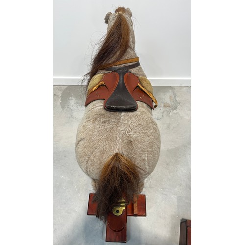 1184 - Norman Thelwell rocking horse on trestle stand, 113cm long.