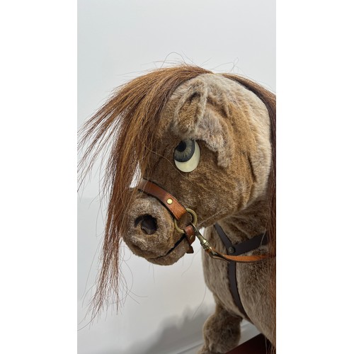 1184 - Norman Thelwell rocking horse on trestle stand, 113cm long.