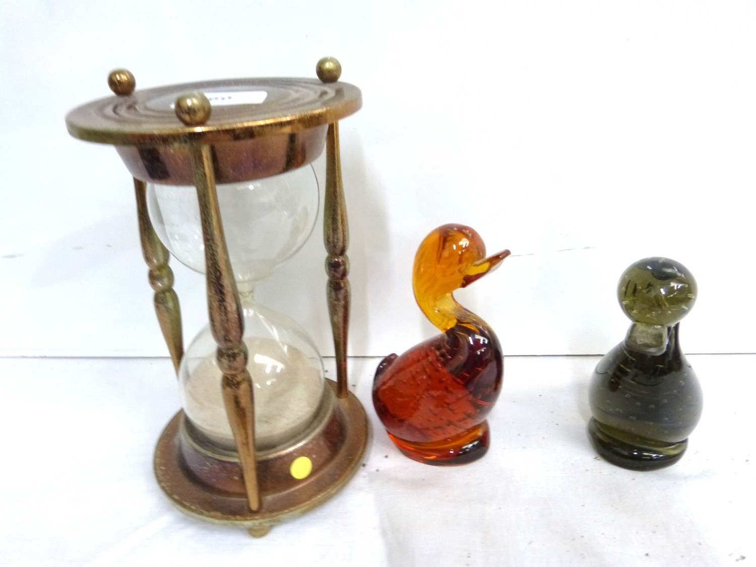 Two glass duck paperweights each 14cm and large hour glass timer. (3)