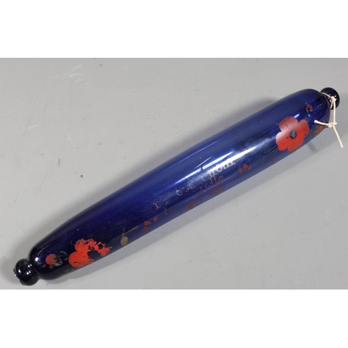 Blue glass rolling pin with faded poppy decoration, inscription from ...