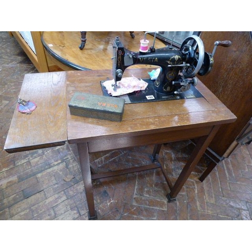 102 - Early 20thC 'Vesta' cast iron sewing machine in oak table