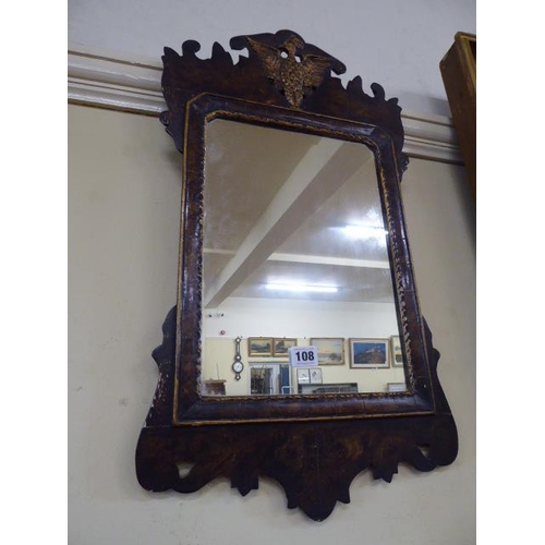 108 - Regency style walnut wall mirror with carved golden eagle motif in pediment