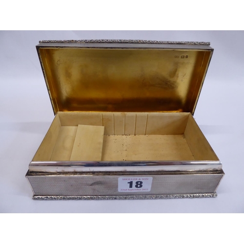 18 - Mappin & Webb engine turned silver gilt interior cigarette box with a raised floral border