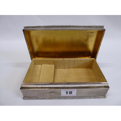 18 - Mappin & Webb engine turned silver gilt interior cigarette box with a raised floral border