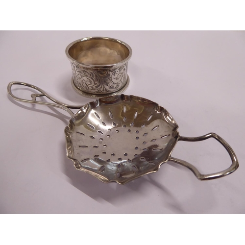 59 - Silver napkin ring and tea strainer (2)