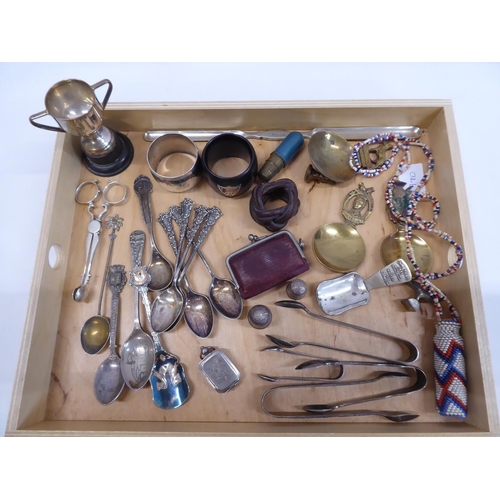 61 - Tray of miscellaneous - brass spoons, napkin rings, African beaded scent bottle, silver thimbles etc... 