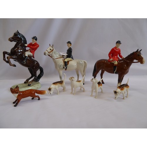 5 - Beswick hunting figures - two huntsmen, huntswoman on piebald grey horse, four hounds and a fox