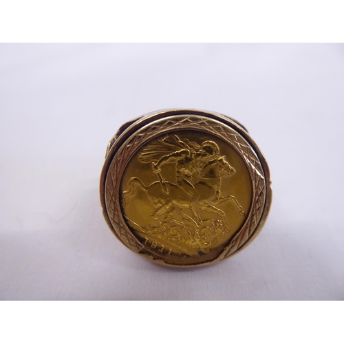 31 - 1911 gold sovereign mounted in 9ct pierced St George design gents ring (15.2g)