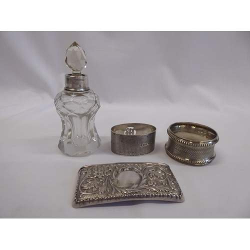 79 - Silver napkin rings, card case, silver rimmed glass scent bottle (4)