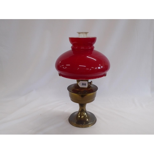 Aladdin brass oil lamp with red glass shade