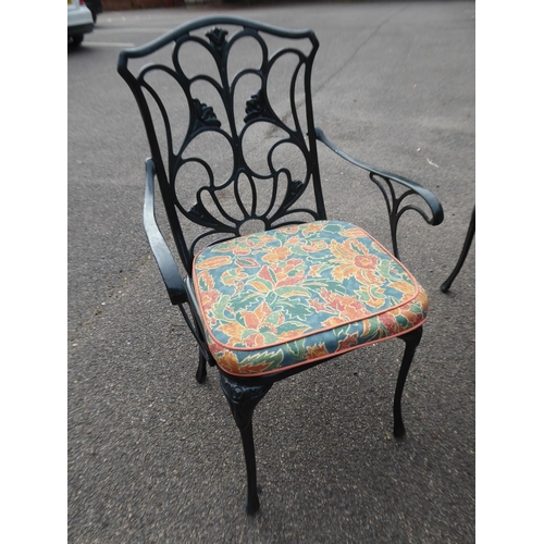 2 - Ornate cast garden table and 6 chairs (with cushions)