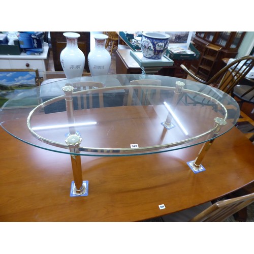 528 - Large oval brass base glass top coffee table