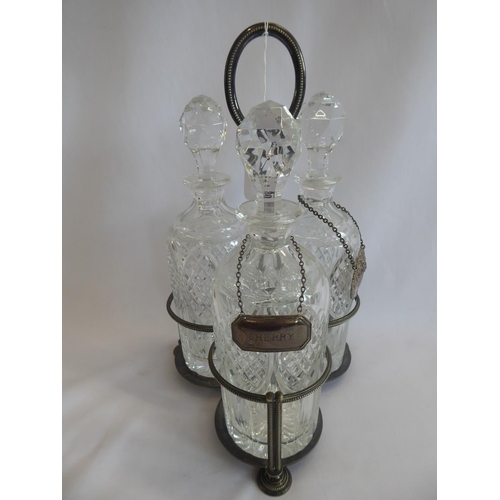 80 - Trio of cut glass decanters with 2 silver labels on plated stand