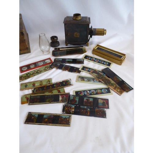 259 - Early 20thC German magic lantern - approximately 30 coloured slides in pine box