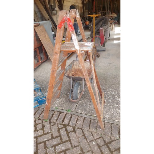 23 - Wheel barrow and step ladder