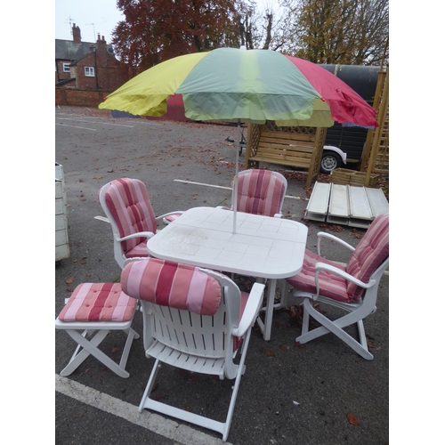 31 - Heavy duty white plastic folding garden table and chairs, cushions and parasol, side tables
