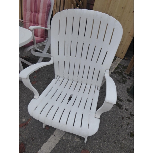 31 - Heavy duty white plastic folding garden table and chairs, cushions and parasol, side tables