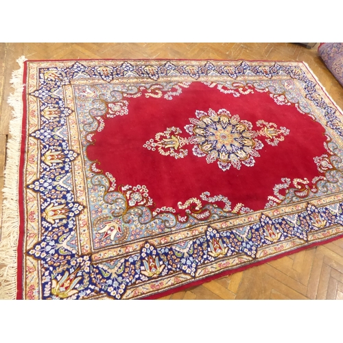 625 - Red ground Persian Kerman rug with floral medallion design