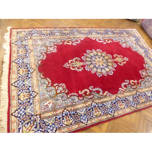 625 - Red ground Persian Kerman rug with floral medallion design