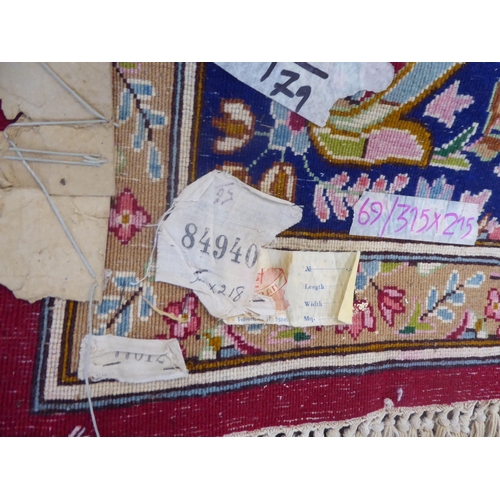 625 - Red ground Persian Kerman rug with floral medallion design