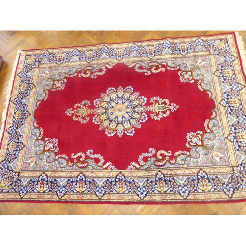 625 - Red ground Persian Kerman rug with floral medallion design