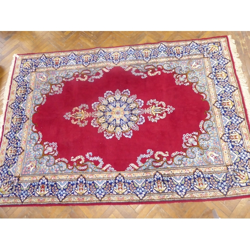 625 - Red ground Persian Kerman rug with floral medallion design