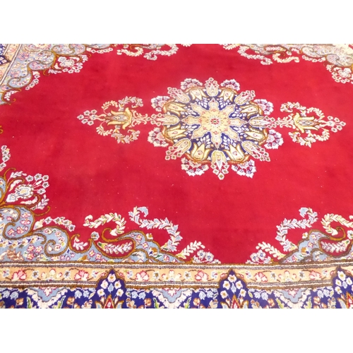 625 - Red ground Persian Kerman rug with floral medallion design