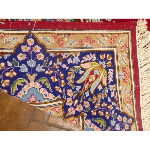 625 - Red ground Persian Kerman rug with floral medallion design
