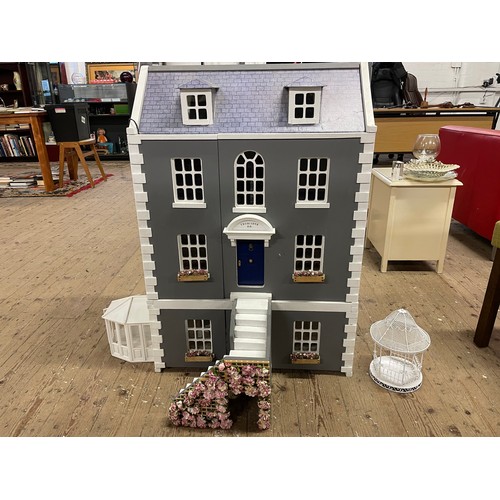 242 - Four storey wooden dolls house with, Steps, lighting, conservatory, band stand, and other accessorie... 