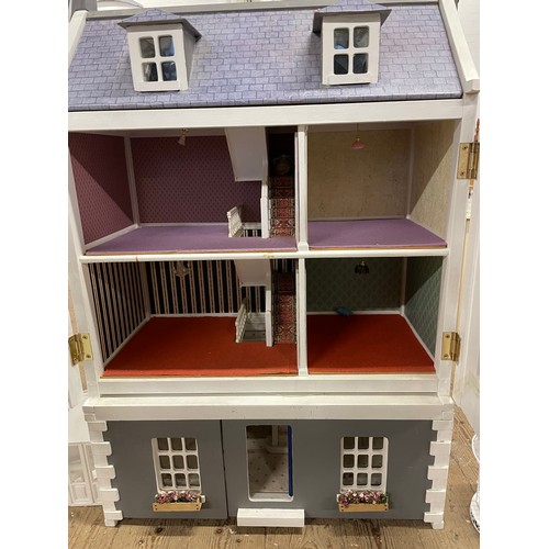 242 - Four storey wooden dolls house with, Steps, lighting, conservatory, band stand, and other accessorie... 