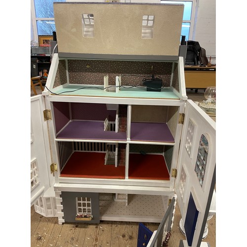 242 - Four storey wooden dolls house with, Steps, lighting, conservatory, band stand, and other accessorie... 