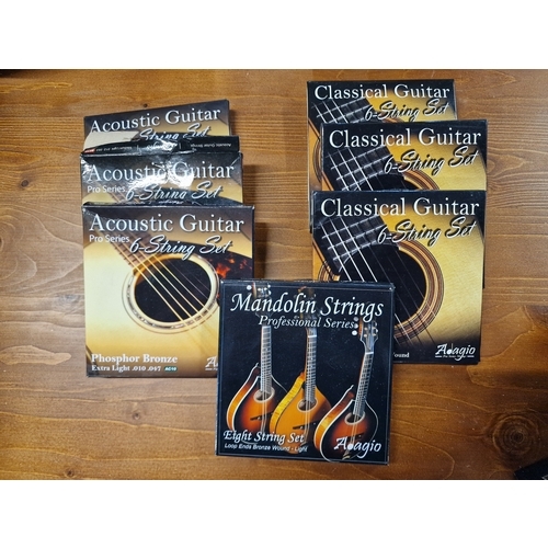 107 - A selections of guitar strings, acoustic, classical and mandolin