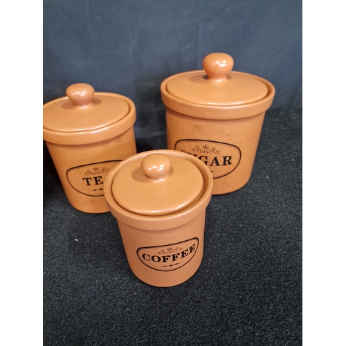 44 - A selection of terracotta kitchens utensils- Flour, sugar, tea and coffee